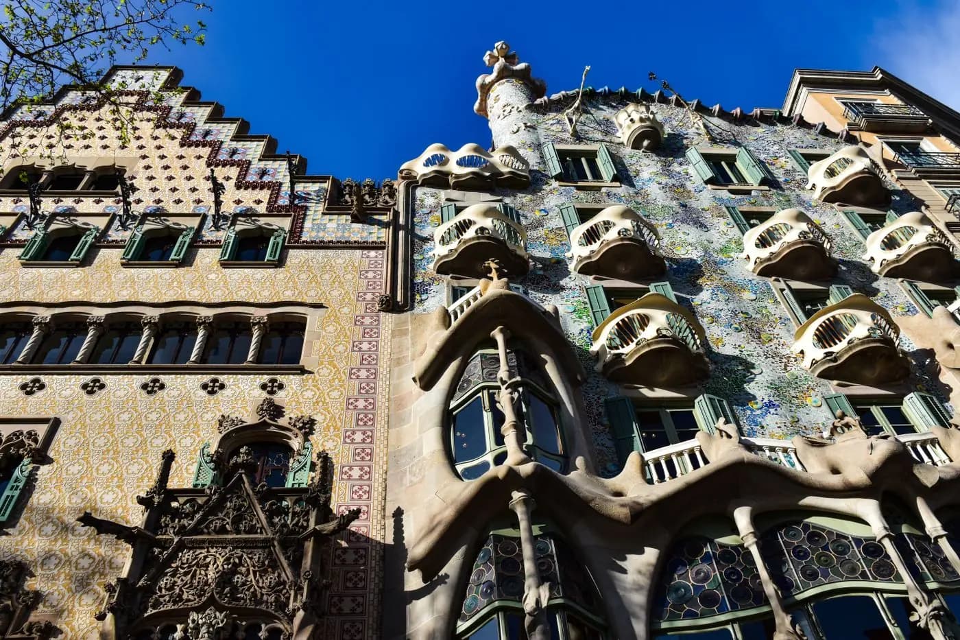 Gaudí's Casa Batlló facade with bone-like balconies and colorful mosaics