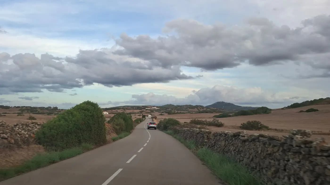 Country road lined with dry stone walls in the Menorcan landscape