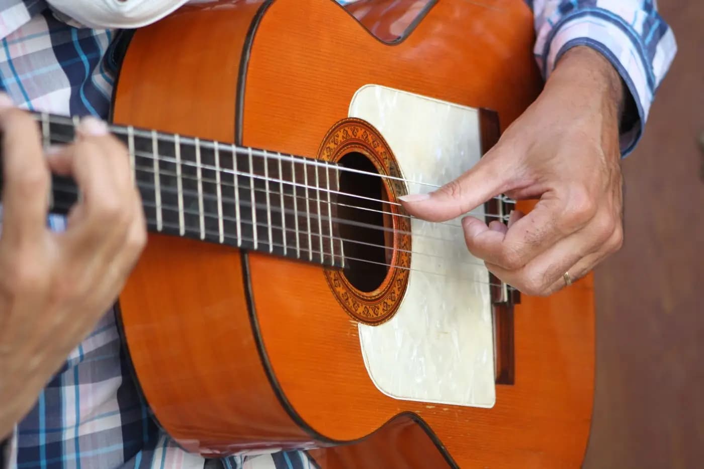 Close-up of a flamenco guitarist's hands on a guitar