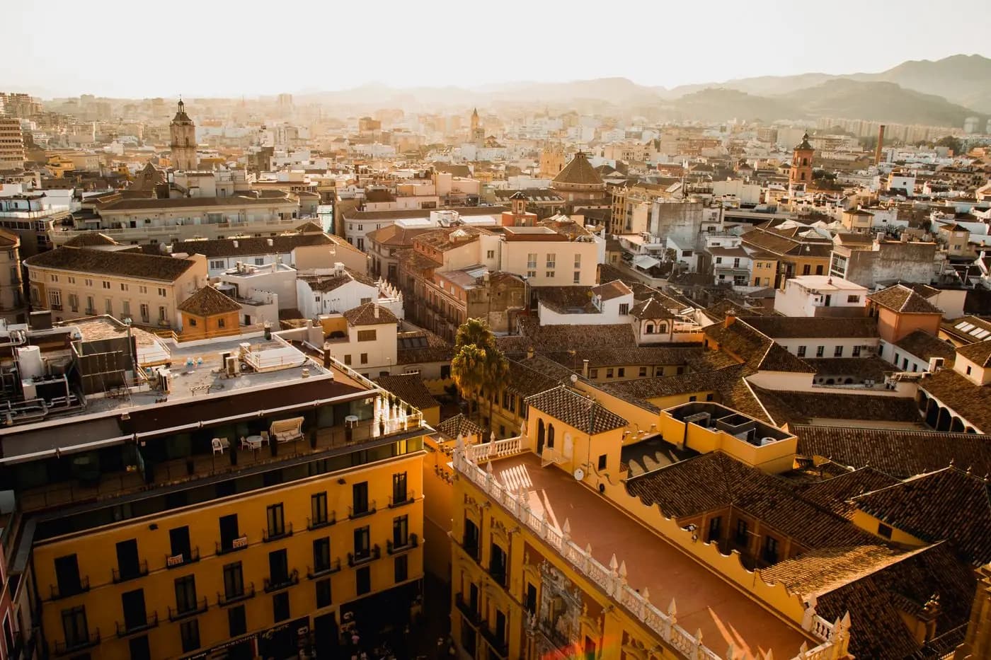 Aerial view of Málaga's old town rooftops at sunset