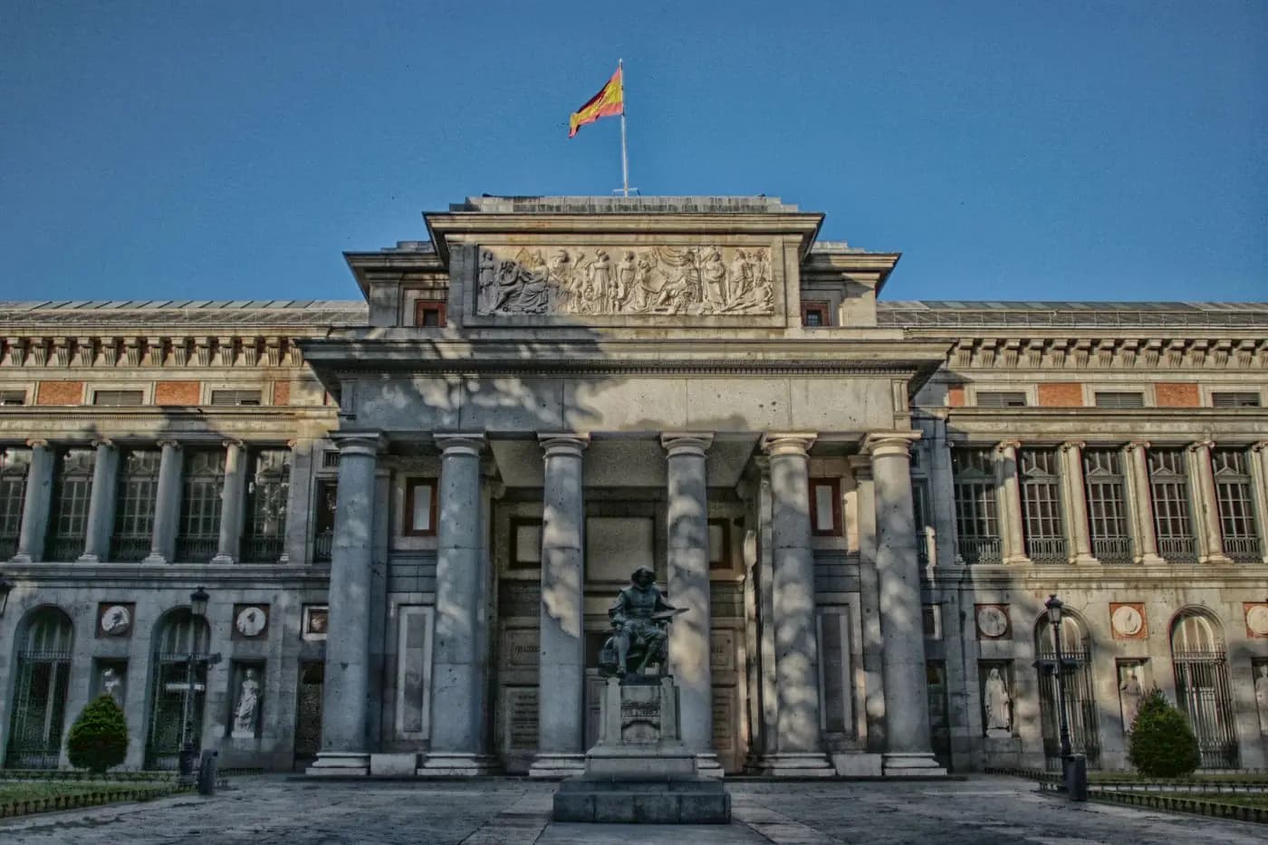 Neoclassical Prado Museum facade with Velázquez statue in front
