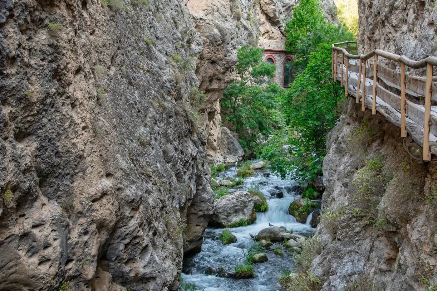 Rocky gorge with a stream and a wooden walkway, Granada province
