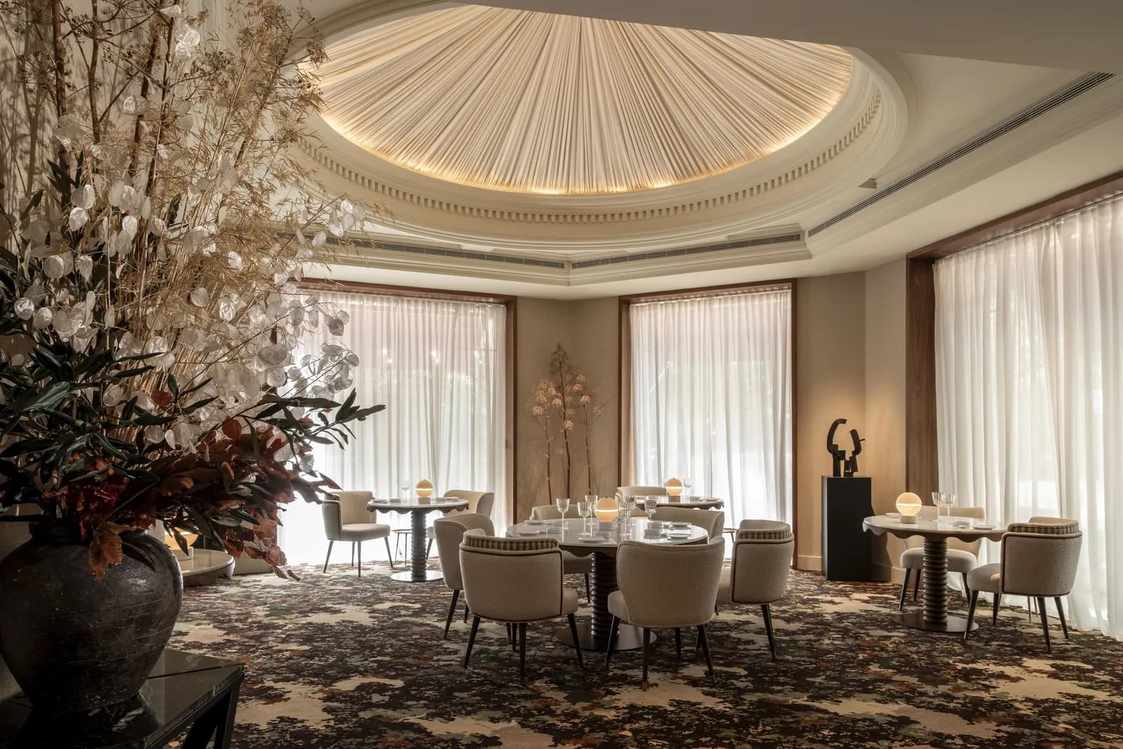 Dome dining room of Coque restaurant in Madrid with tables set under a curved ceiling