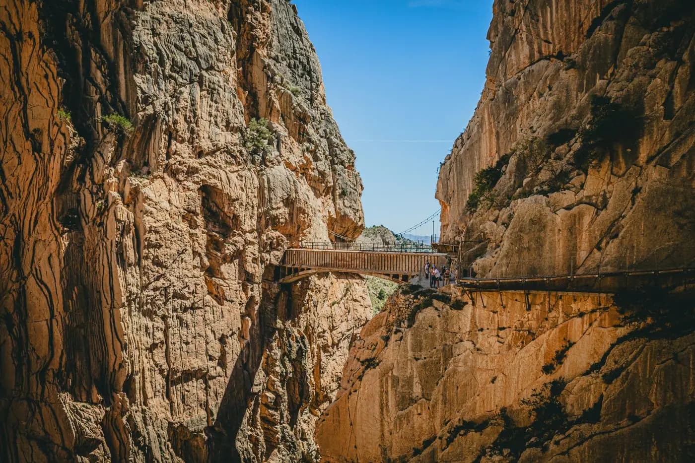 Wooden walkway suspended between the gorge walls of Caminito del Rey