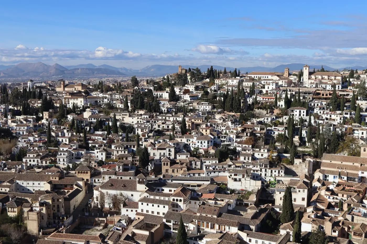 Aerial view of the Albaicín district in Granada, with its whitewashed houses and cypress trees