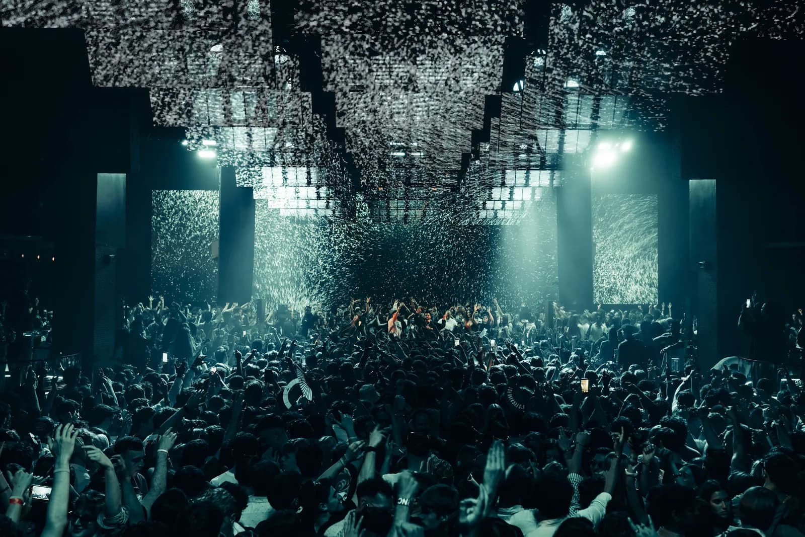 Dense crowd under a lit ceiling inside Hï Ibiza club