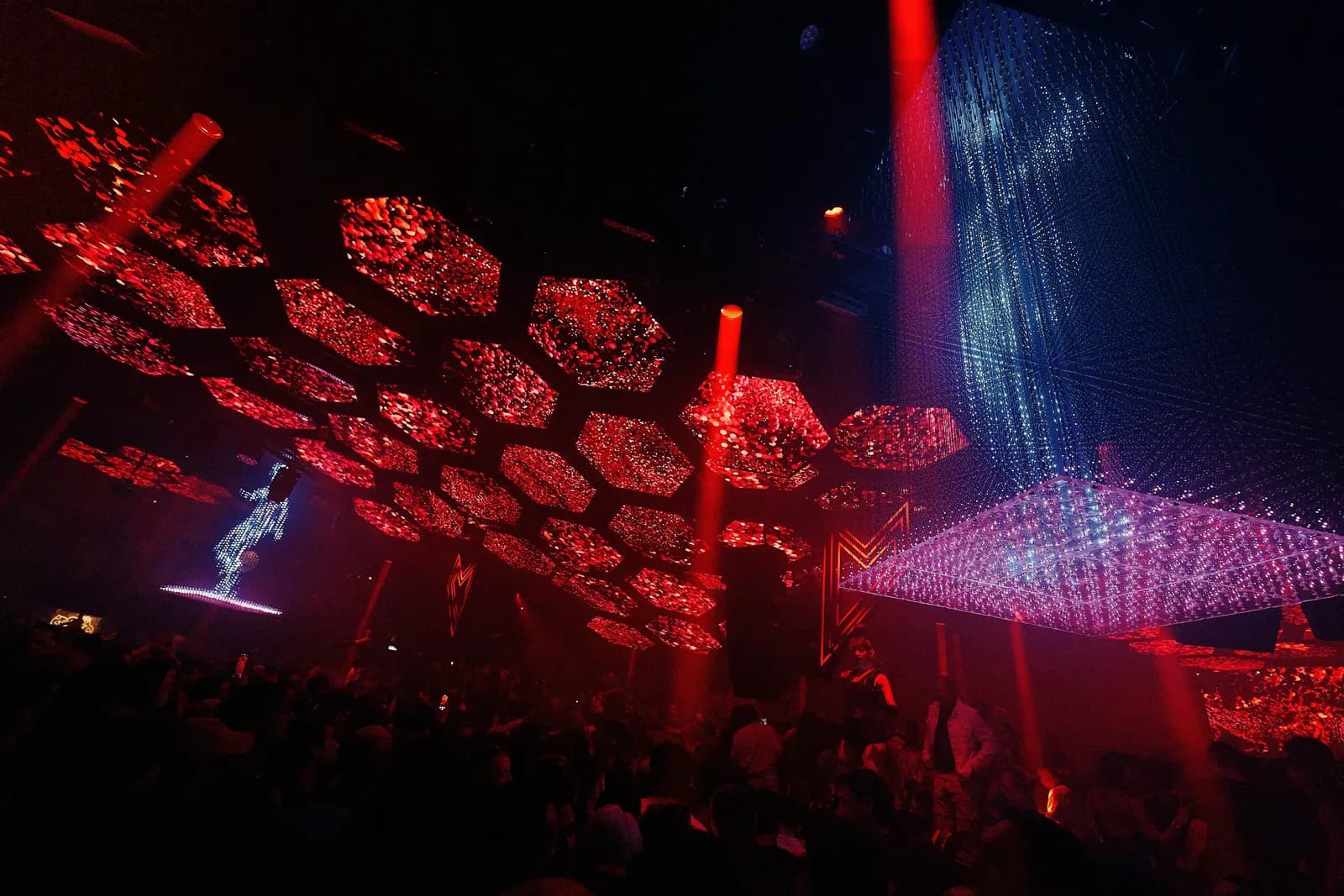 Red lattice ceiling and light beams in the Pacha Ibiza main room