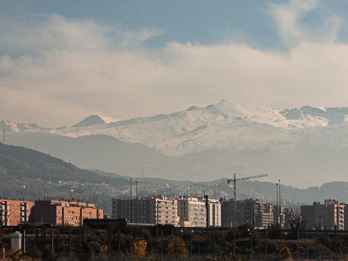 Granada, the city rooftops and the snow-capped Sierra Nevada in the background