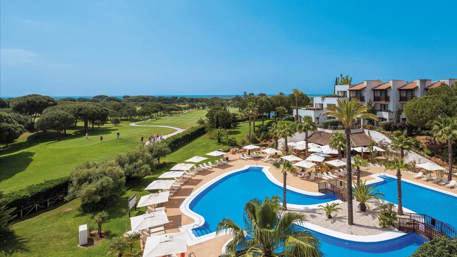 Aerial view of the pool and golf course at Precise Resort in El Rompido