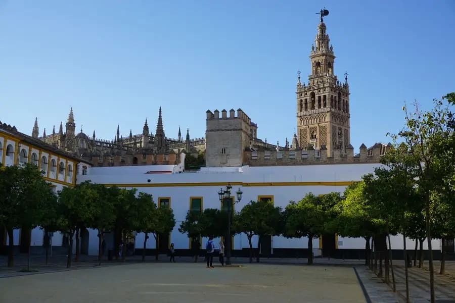 La Giralda and Seville Cathedral seen across a sunlit square