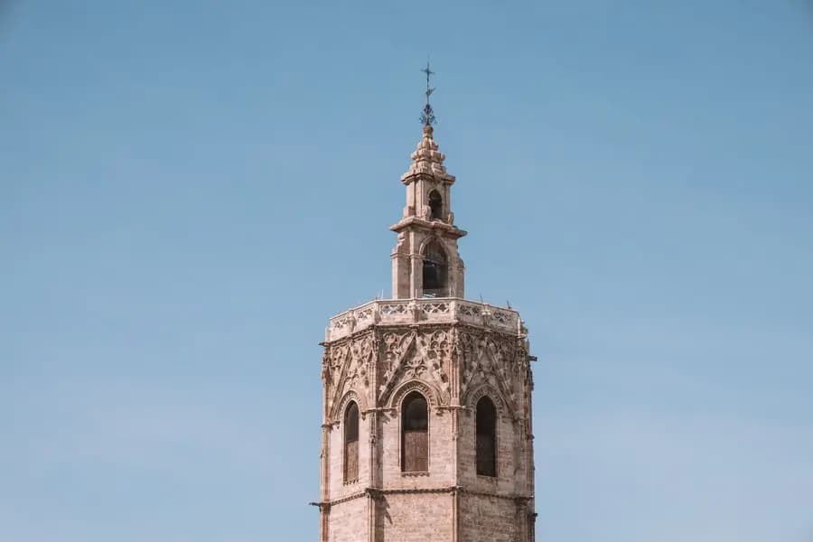 Gothic bell tower of Valencia Cathedral against a clear blue sky