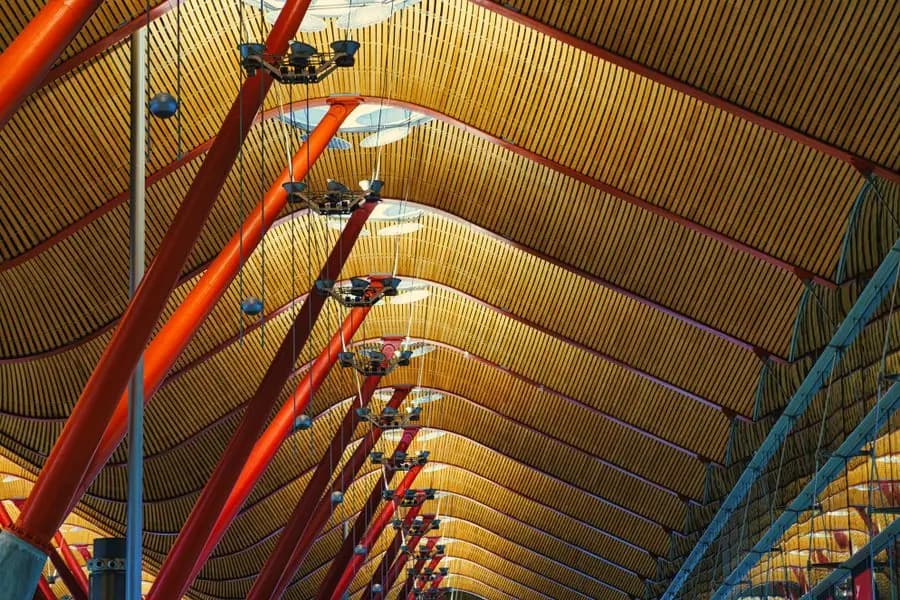 Geometric ceiling of Madrid-Barajas airport with red poles