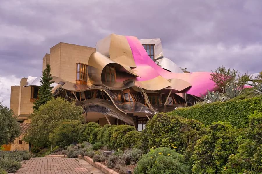 Gold and pink curved façade of the Marqués de Riscal hotel in Elciego