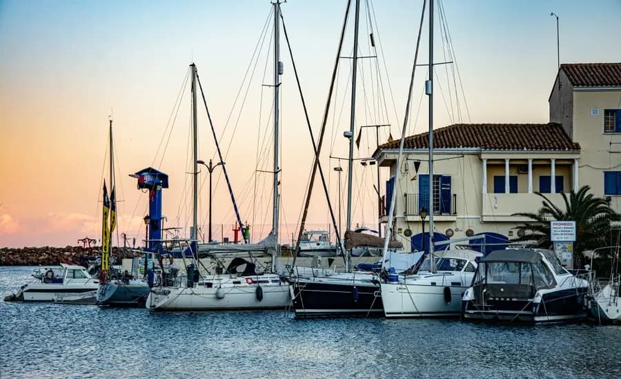 Sailing boats moored at Port Saplaya at dusk