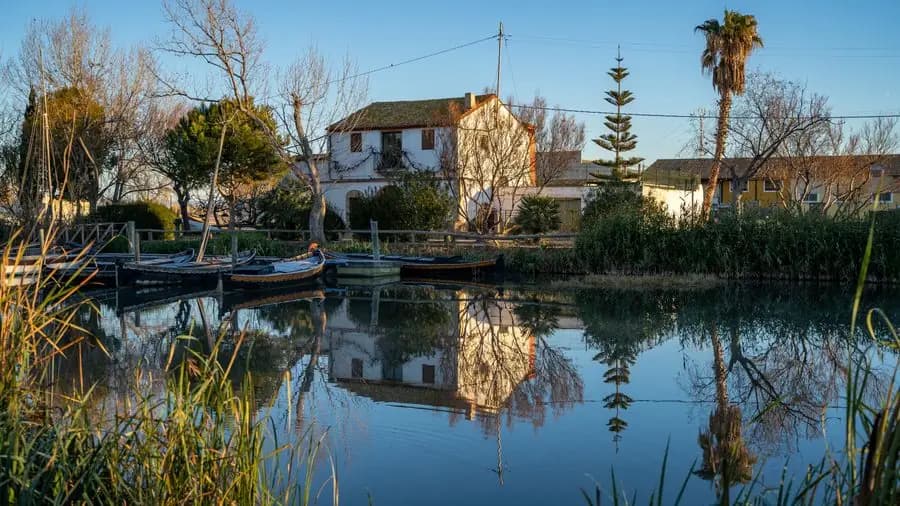 Traditional house reflected in the calm waters of the Albufera