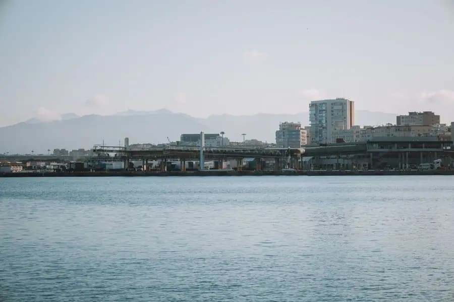 Malaga harbour and city skyline with mountains behind