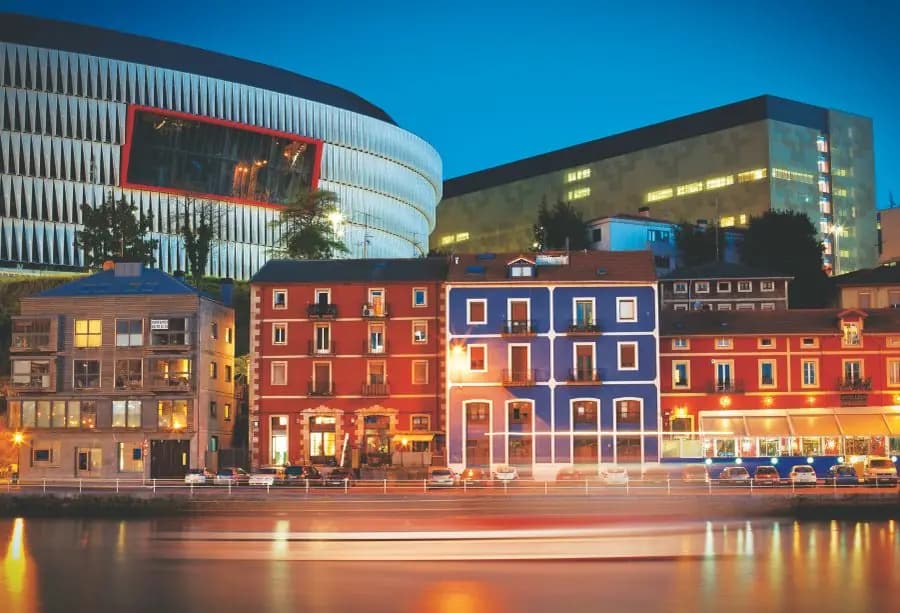 Riverside buildings in Bilbao lit up at night