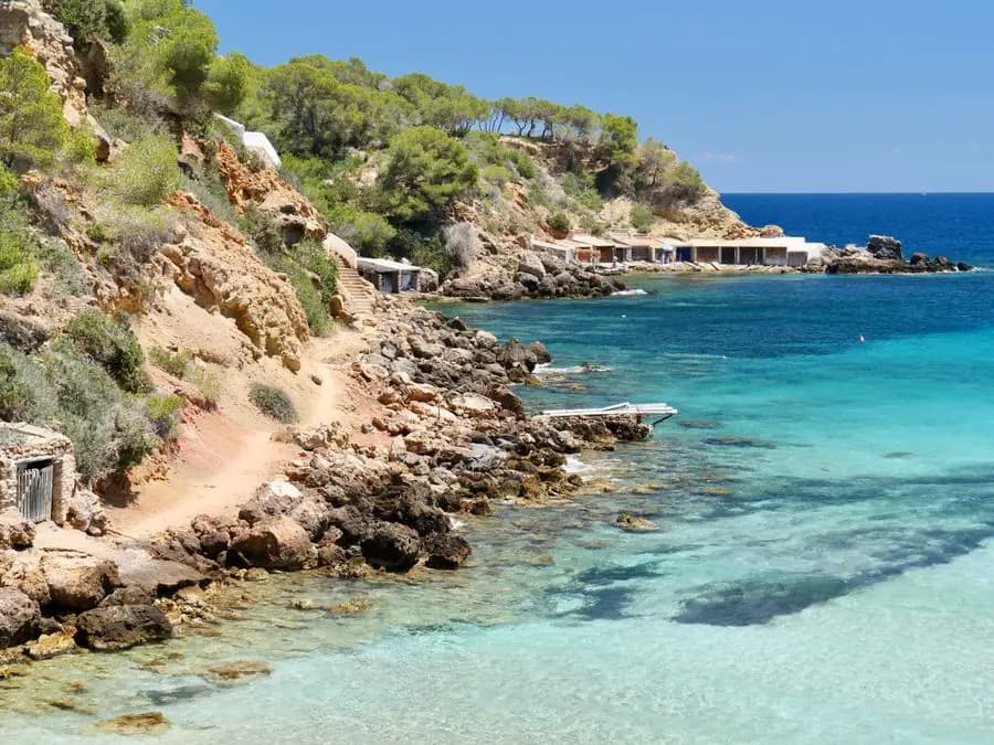 Rocky Ibiza coastline with turquoise water under a clear sky