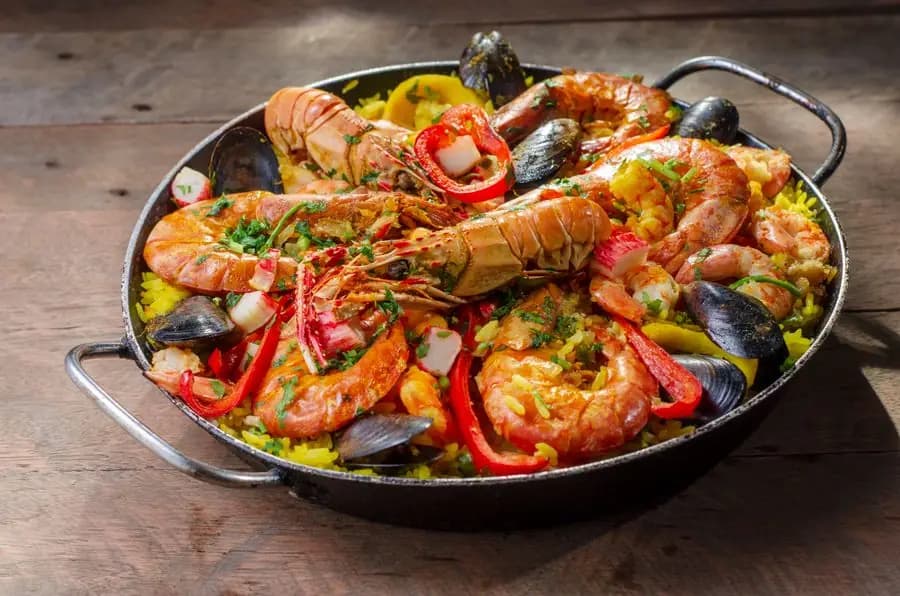 Seafood paella with prawns and mussels, served in its pan
