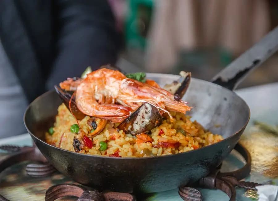 Seafood paella with prawns, served in a rustic pan