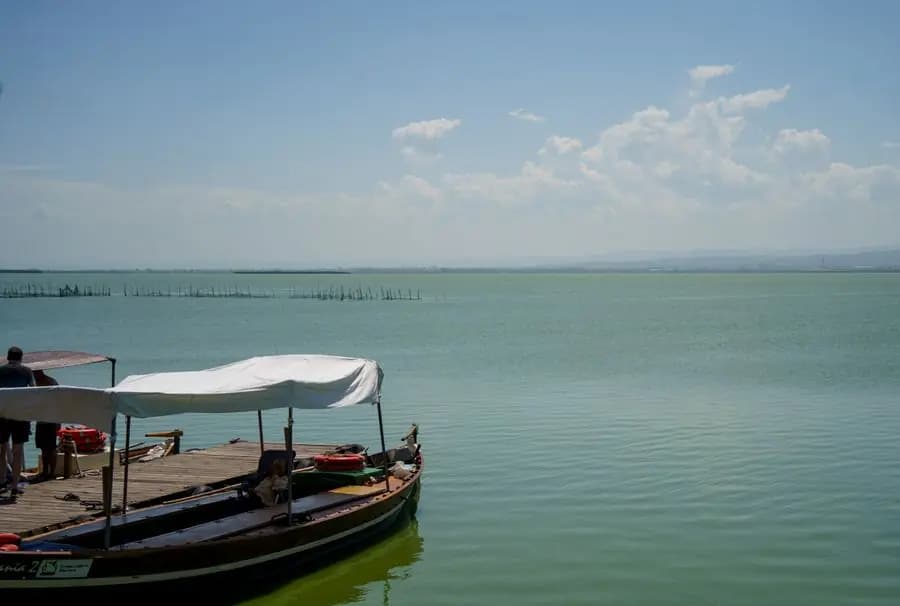 Covered boat moored on a calm lake near Valencia
