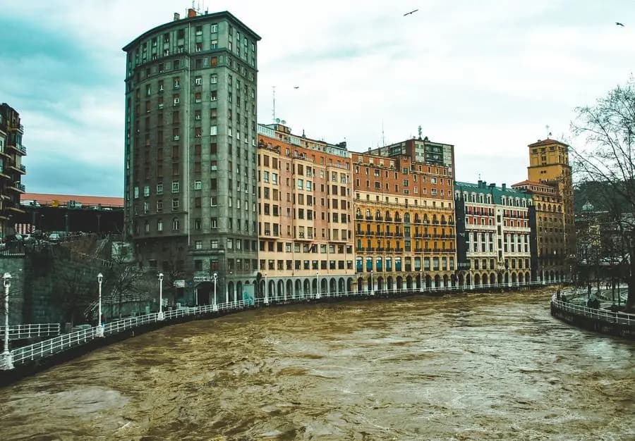 Colourful buildings along the Nervión river in Bilbao, on an overcast day