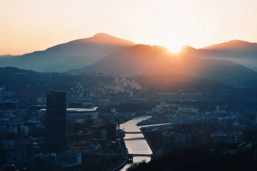 Aerial view of Bilbao at sunset, between the river and the hills