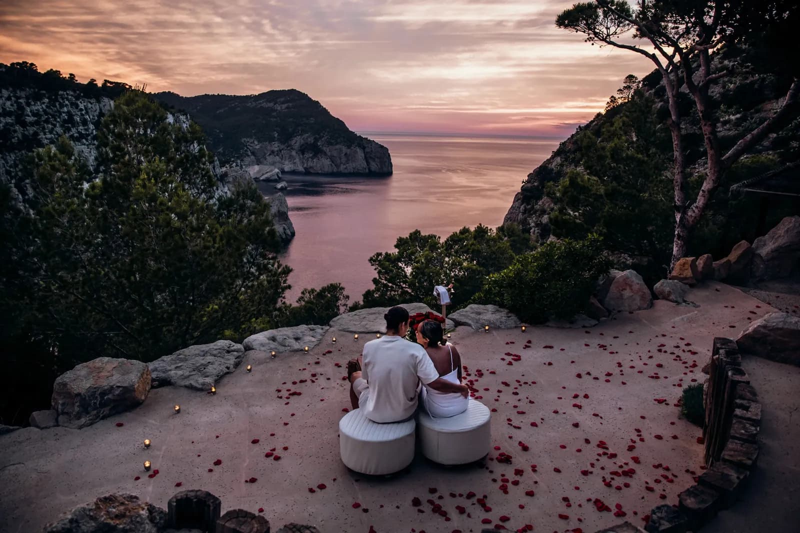 Sunset over the cove of Hacienda Na Xamena in Ibiza, rocky terrace