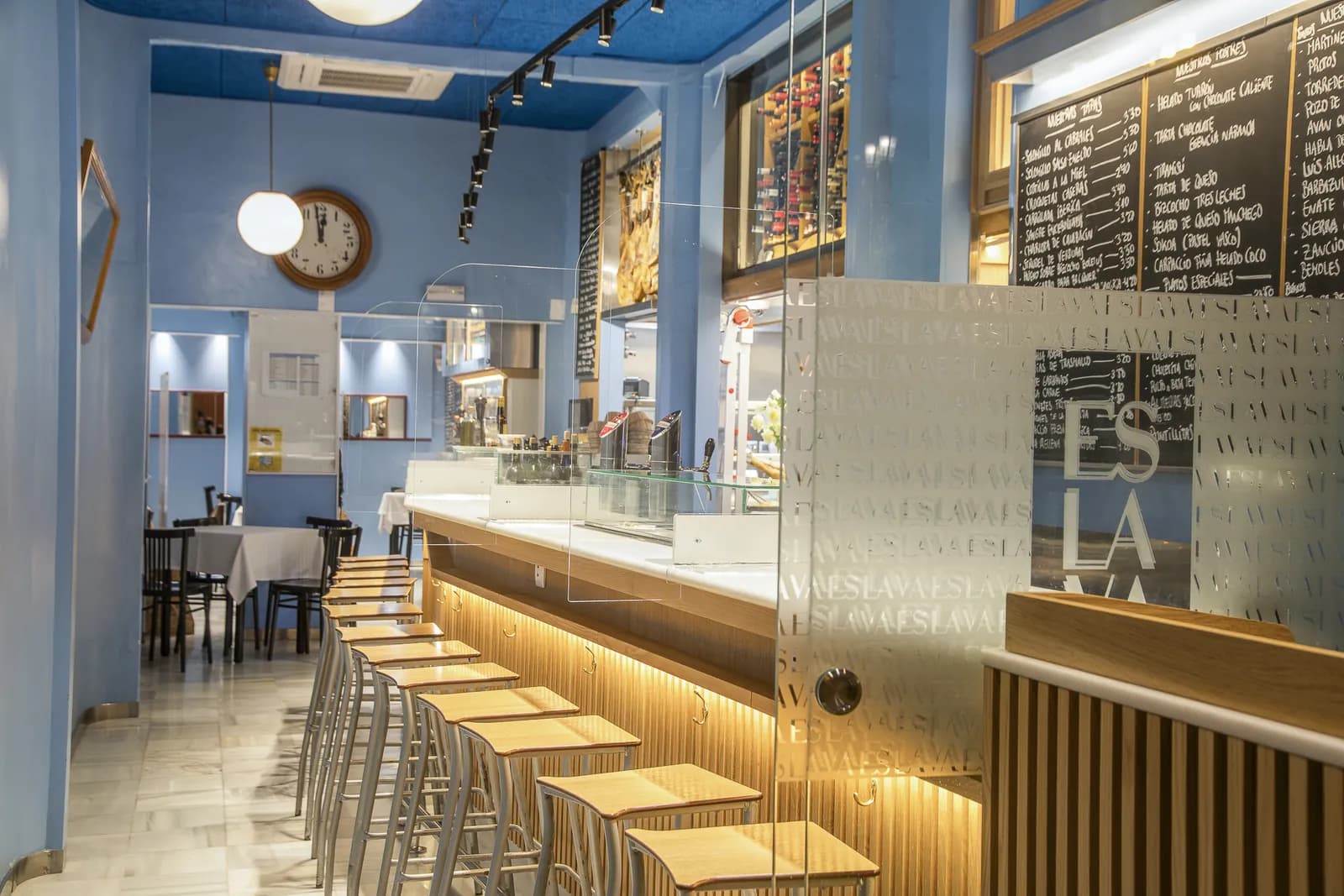 Espacio Eslava bar and dining room with wooden stools in Seville