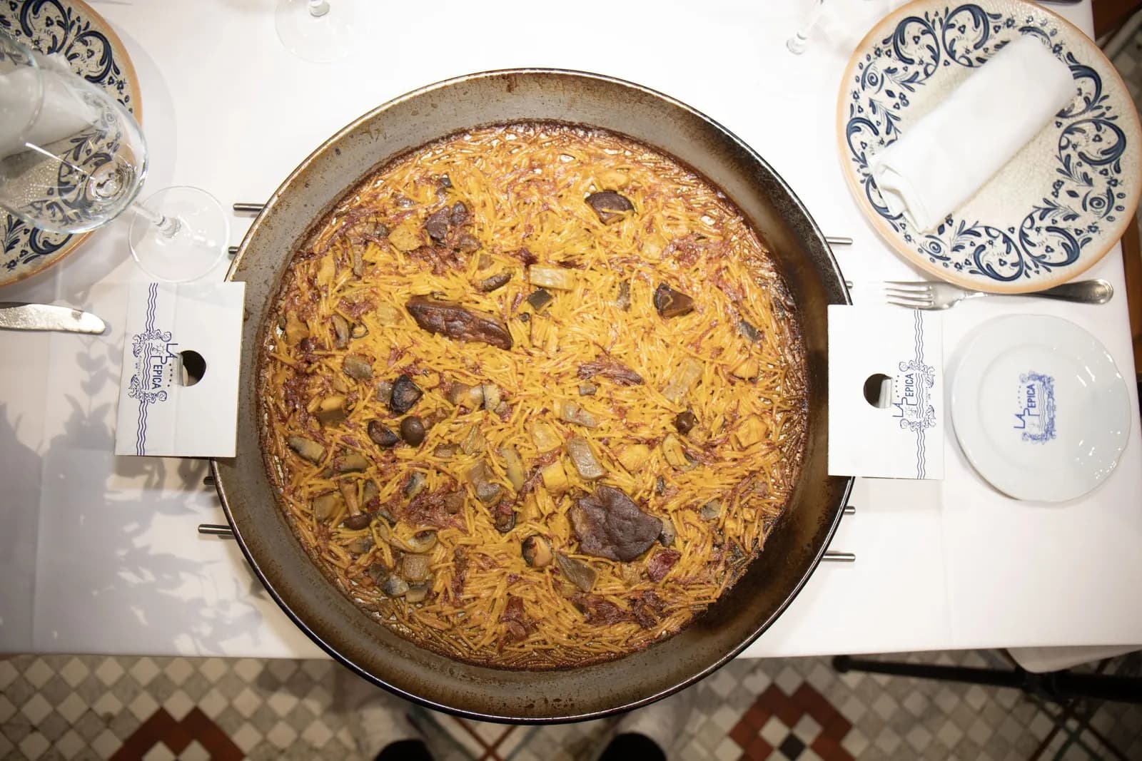 Overhead view of a fideuà noodle dish in its pan