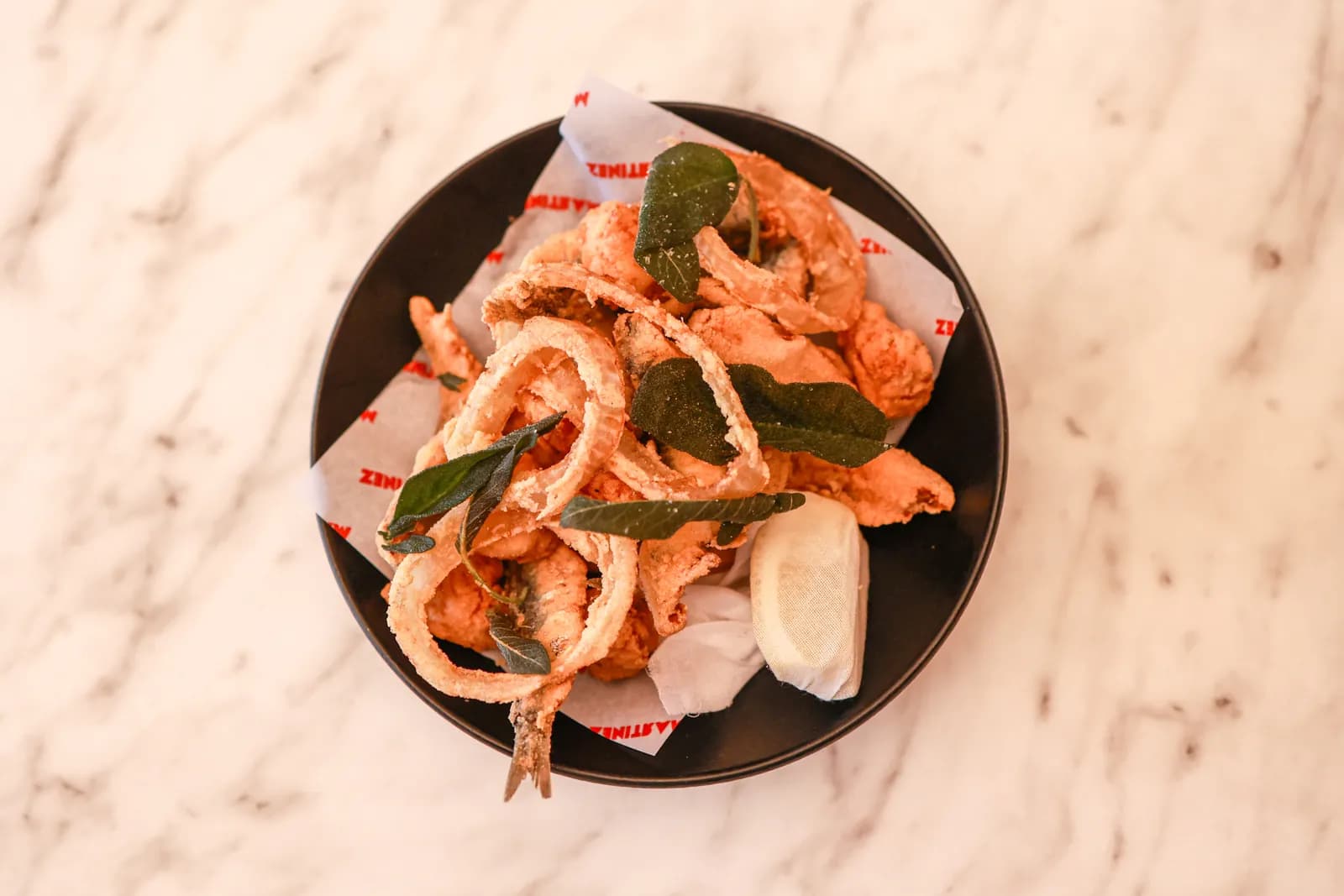 Fried seafood served on a black plate