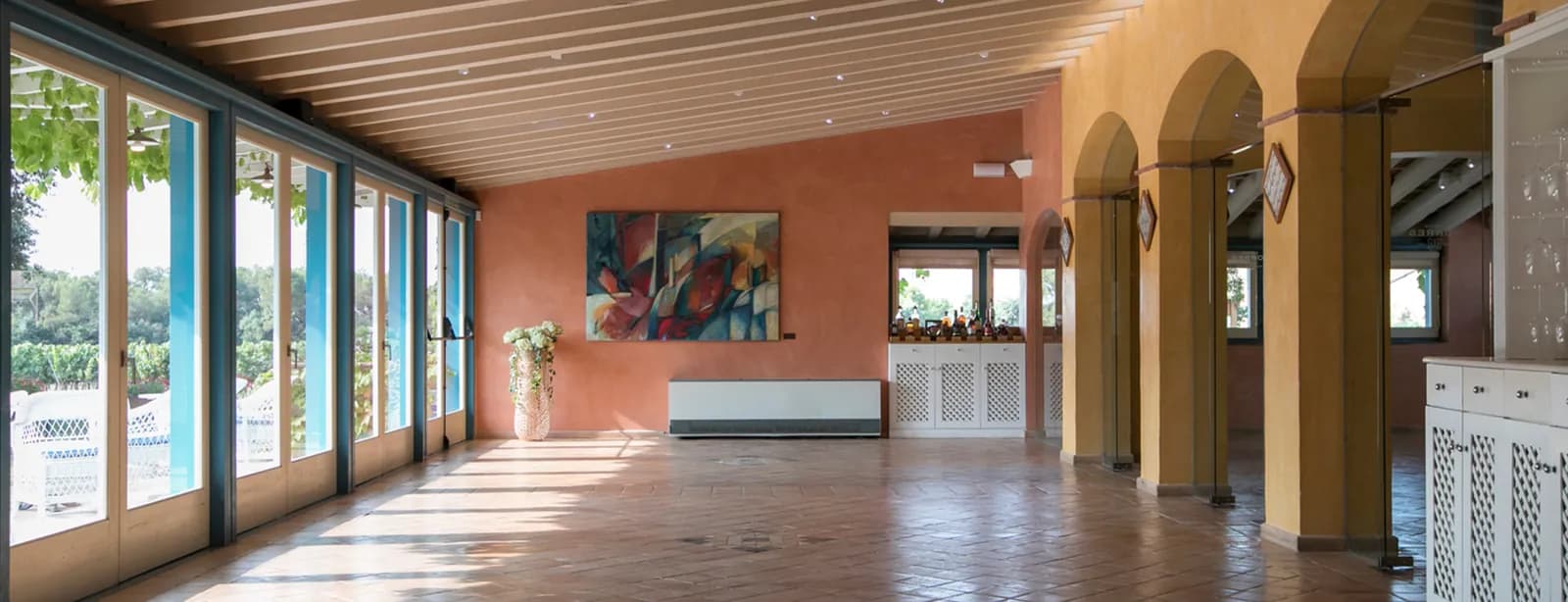 Vaulted dining hall with tall windows at Mas Rabell