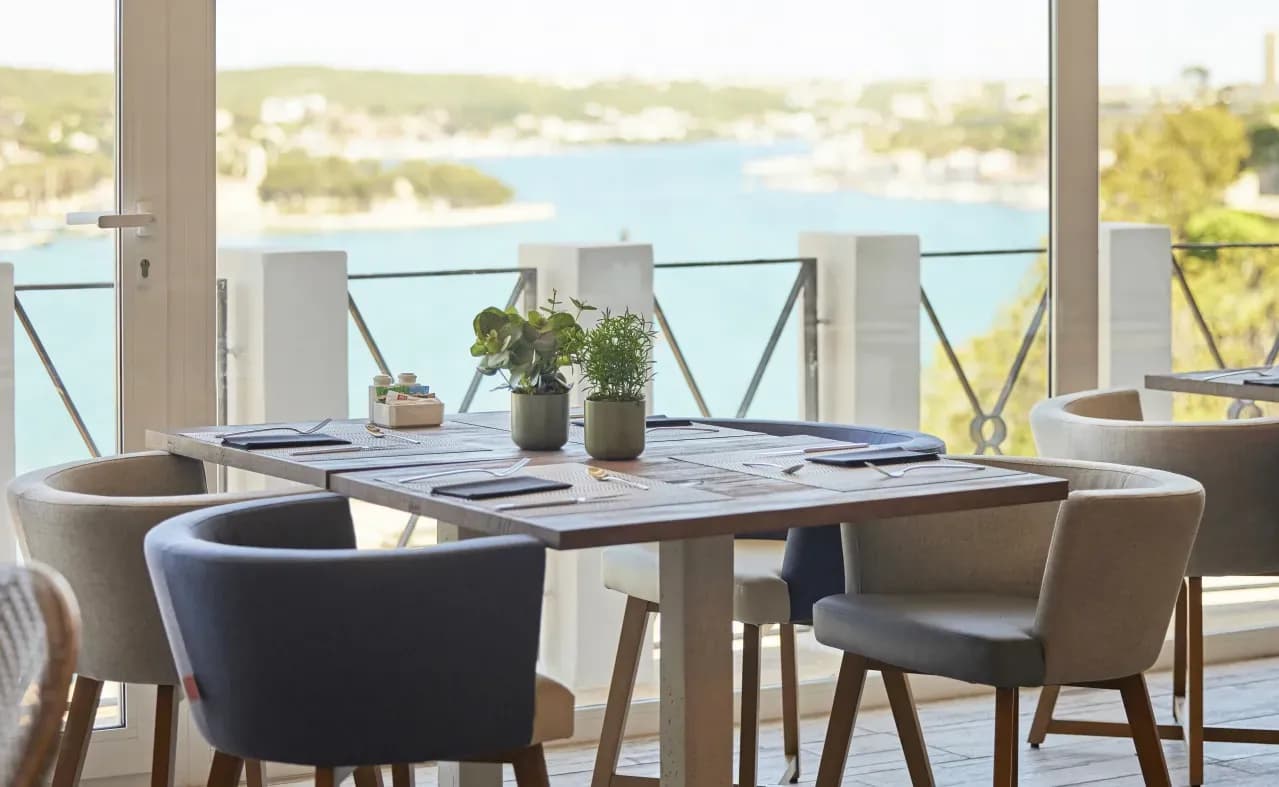 Table set on the Mirador des Port terrace overlooking Maó bay