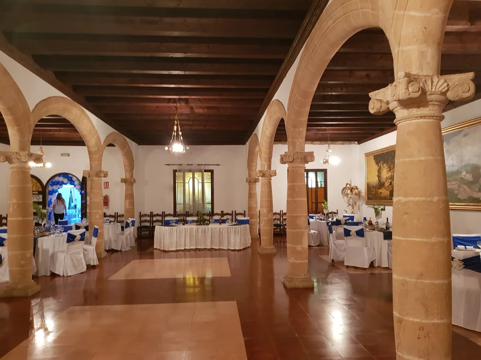 Vaulted dining room with stone columns and laid tables