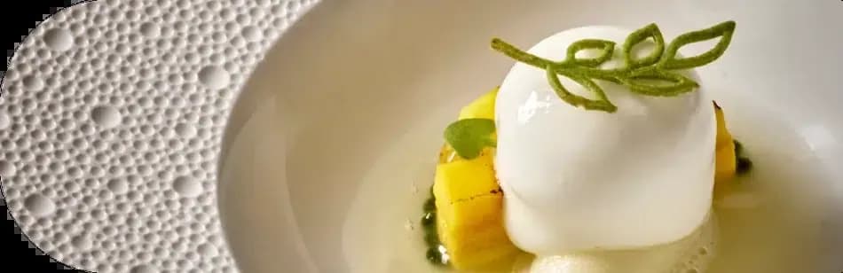 Skina restaurant creation in Marbella, white quenelle on a yellow base