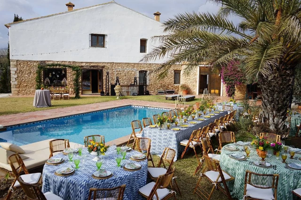 Facade and pool of El Molí del Ballestar near Valencia, tables set on the lawn