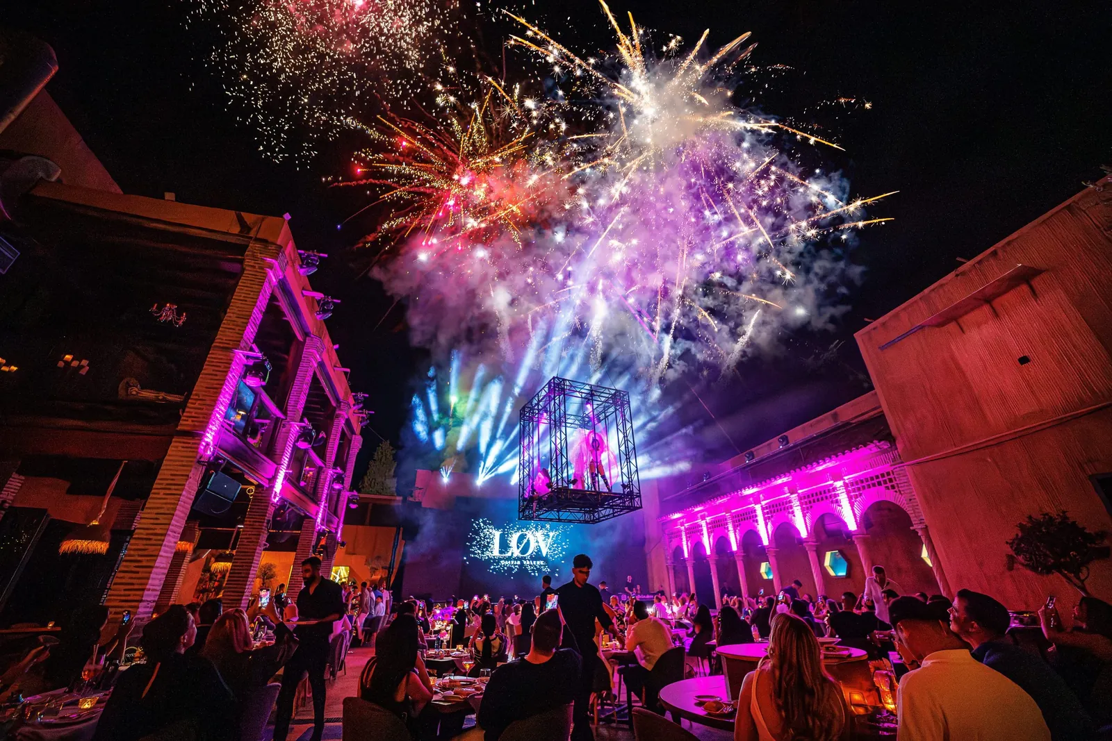 Night view of LØV Marbella with fireworks and crowd outside the venue