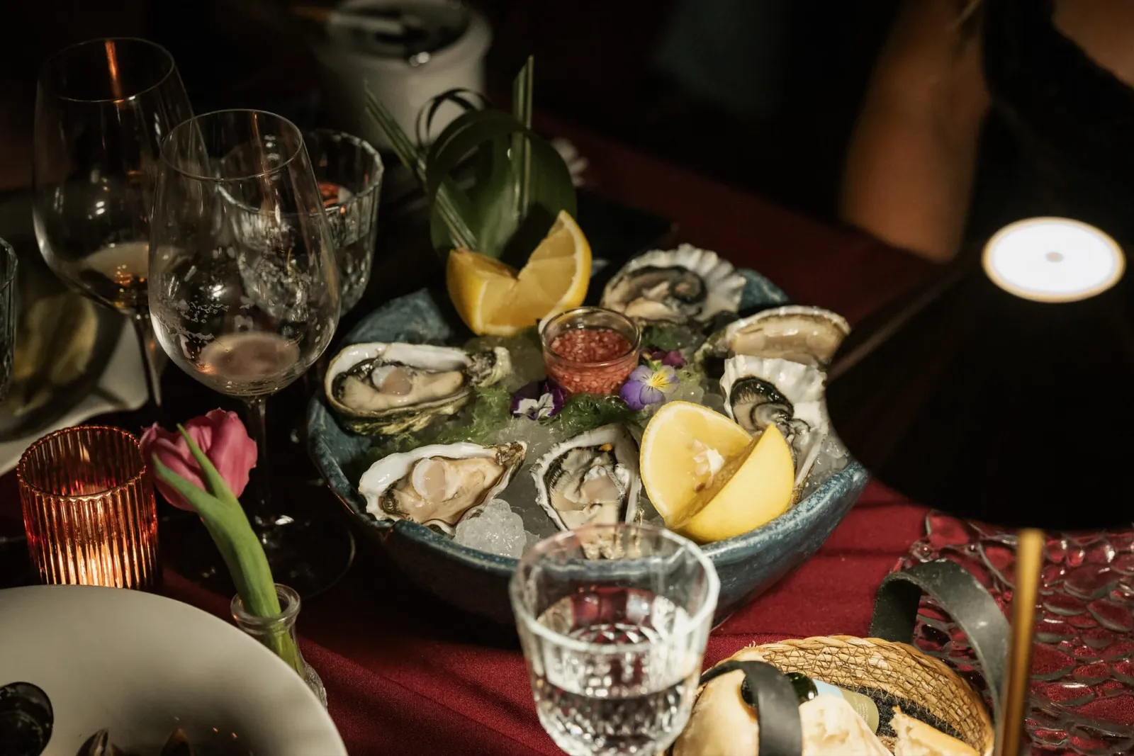 Oysters and lemon wedges on a red tablecloth at LØV Marbella
