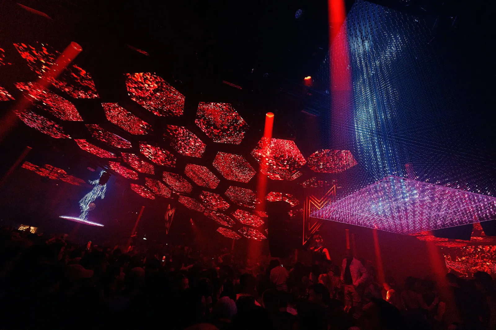 Red lattice ceiling and light beams in the Pacha Ibiza main room