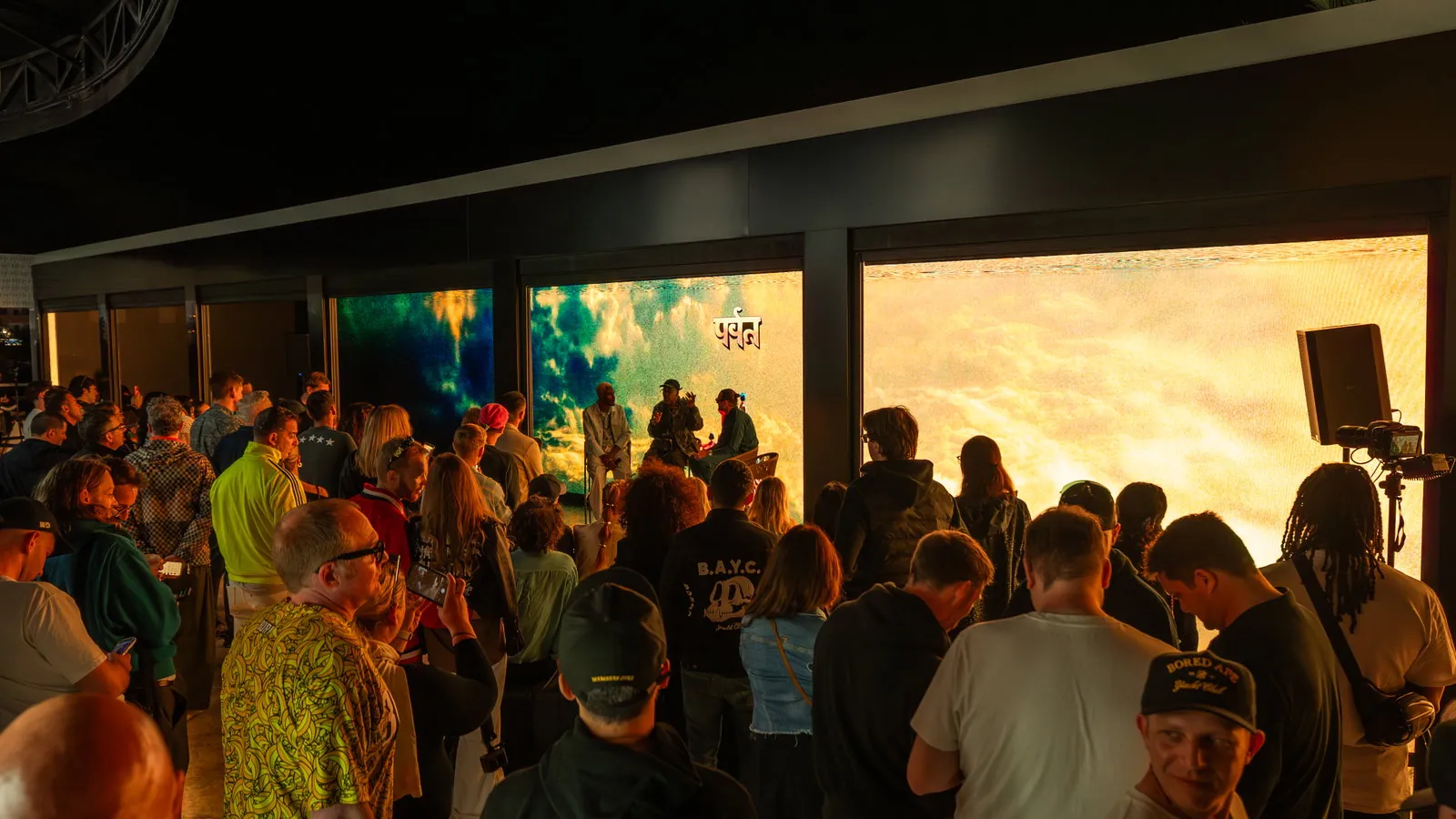 Crowd at Ushuaïa Ibiza in a lounge area with projection screens