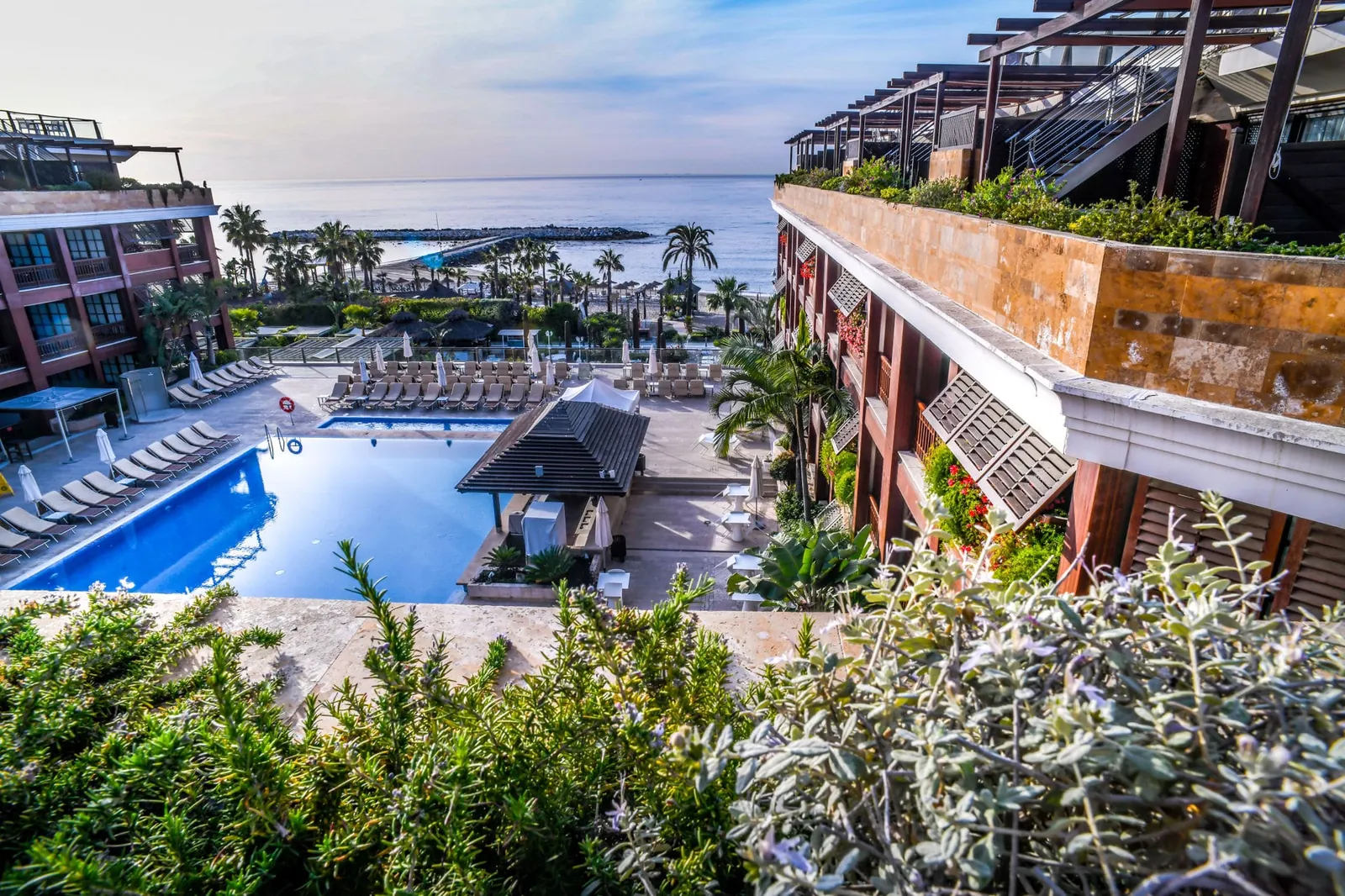Gran Hotel Guadalpín Banús pool and terraces surrounded by greenery in Marbella