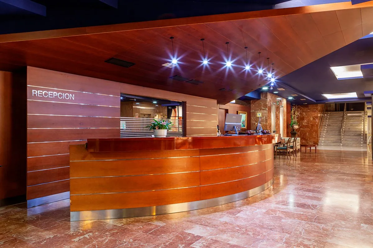 Reception desk of Olympia Hotel, Events & Spa with wood counter in Alboraya