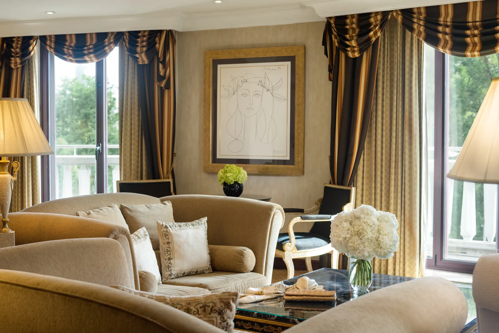 Suite at InterContinental Madrid with sofas, framed artwork and tall windows