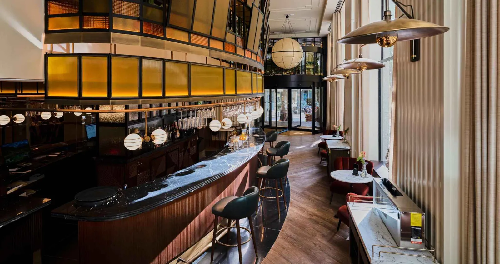 Bar at Only YOU Hotel Valencia with stools and golden lights
