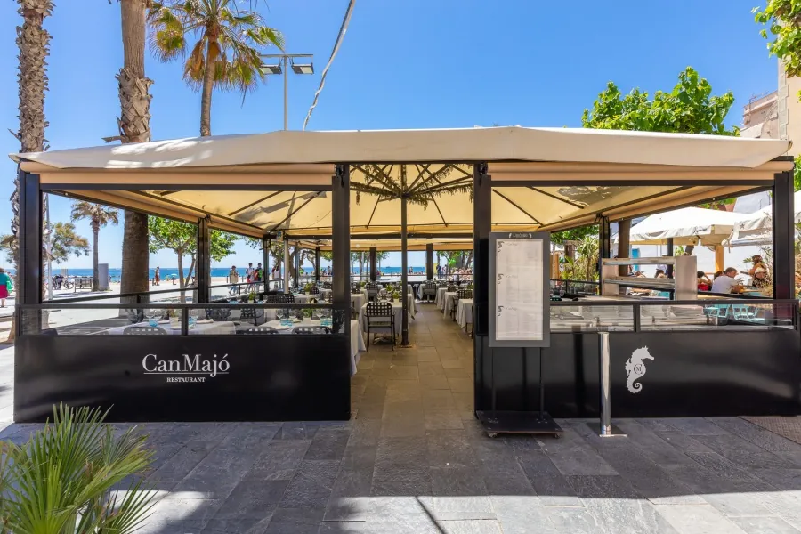 Can Majó terrace with awnings facing the sea in Barcelona