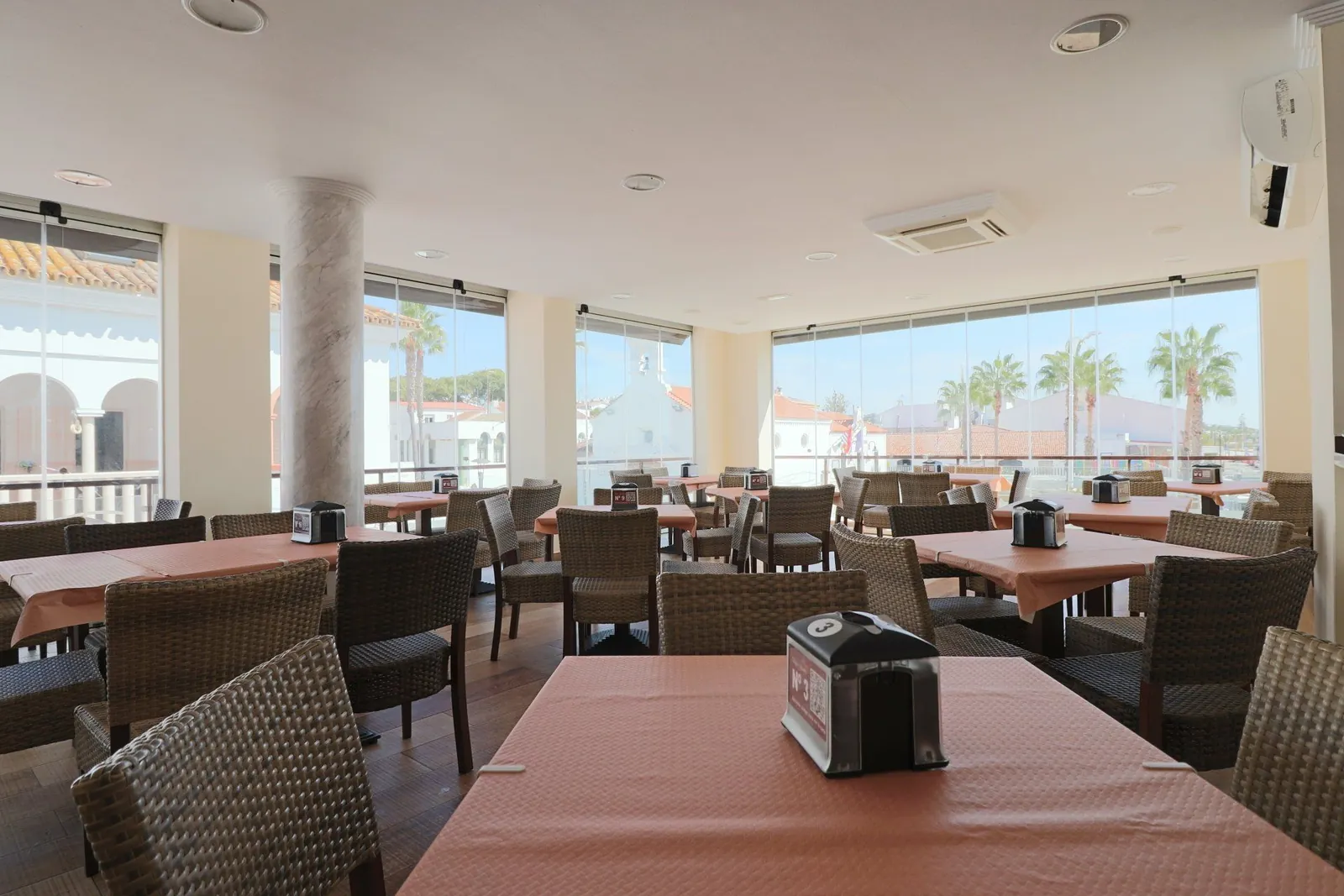 Bright dining room with sea-view windows at Doña Gamba in El Rompido