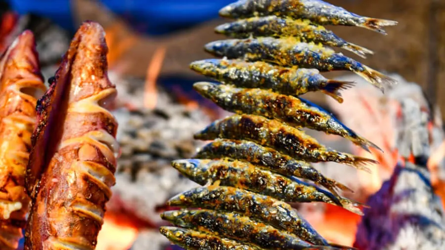Sardines on skewers grilled over wood fire at El Caleño restaurant in Pedregalejo