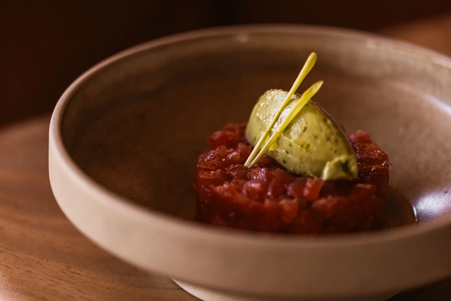 Red tartare served in a dark bowl at El Chiringuito restaurant in Ibiza