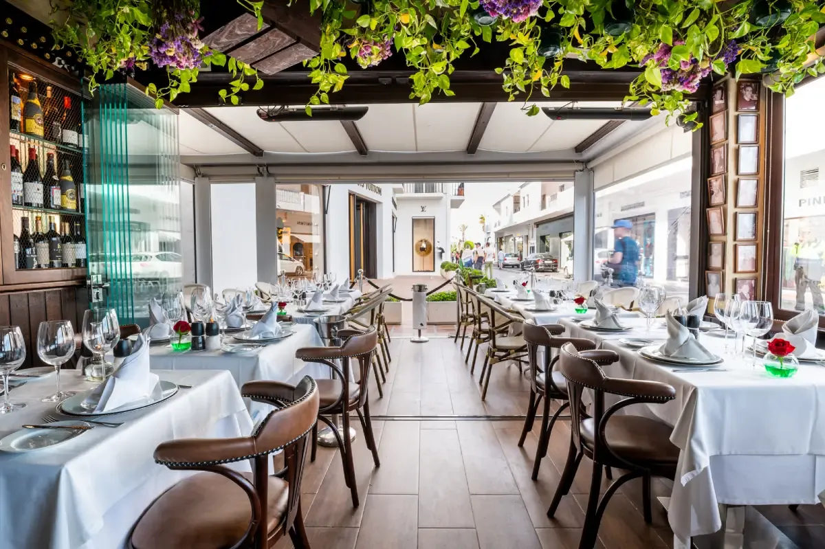 Dining room of Los Bandidos restaurant in Puerto Banús with set tables