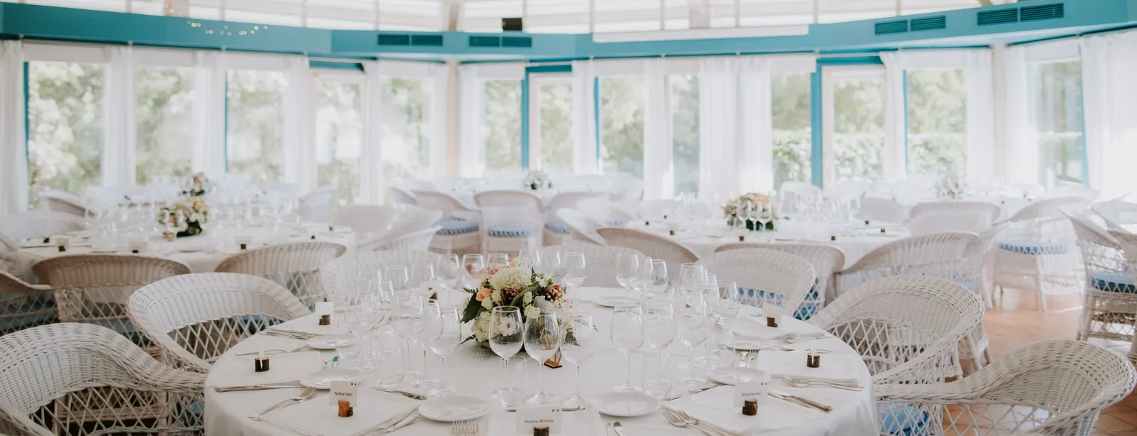 Mas Rabell reception room with round tables and wicker armchairs